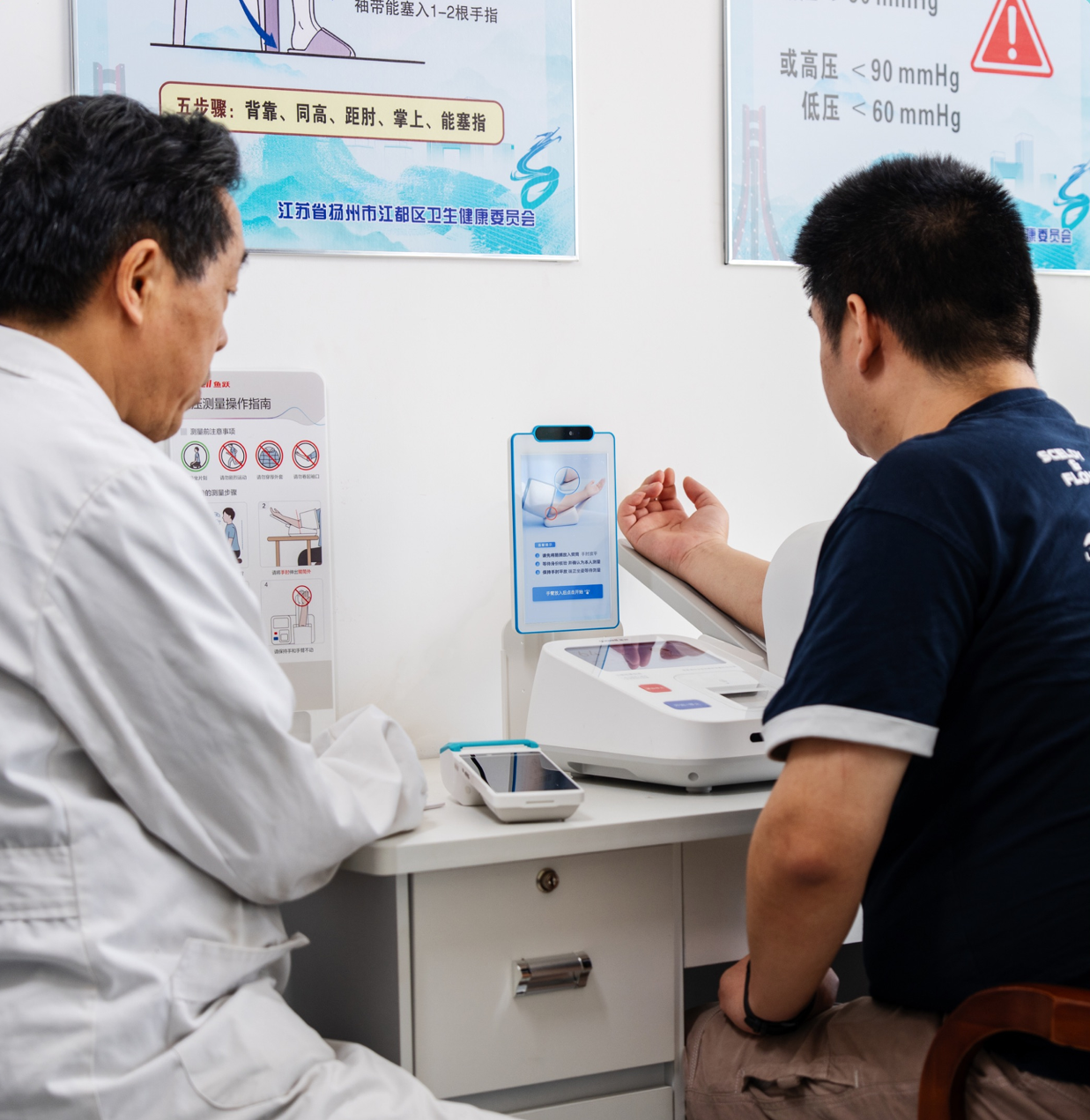 患者在基层社区卫生服务中心使用医保IoT一体化终端进行刷脸认证与血压测量